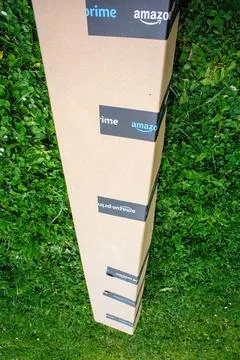 Large and long Amazon Prime parcel cardboard with long good inside - delivered Stock Photos