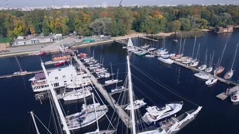 Large and small boats stand on the pier on a summer day within the city - drone Stock Footage 170876301