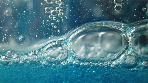 Large and small bubbles fall slowly in blue liquid, fluid background Stock Footage 112529072