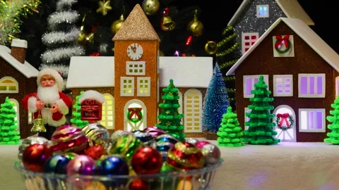 Large and small Christmas tree balls rotate against of a Christmas town Stock Footage 292876128
