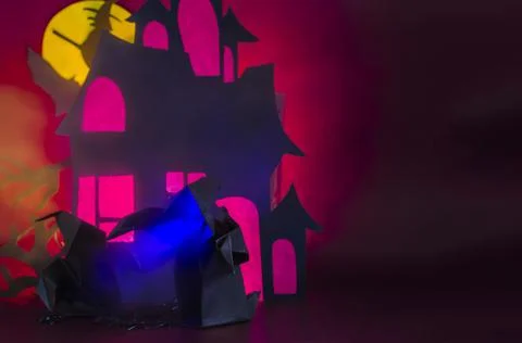 A large and a small ghost with a blue glow in the fog against the background Stock Photos