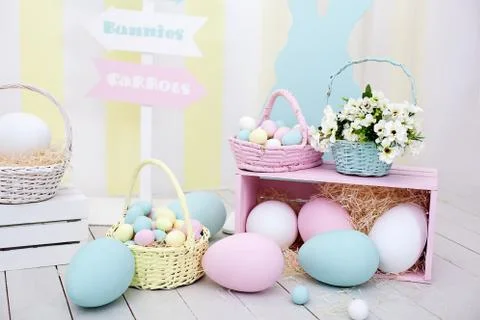 Large and small painted Easter eggs and colorful rabbits. Spring home decor Stock Photos
