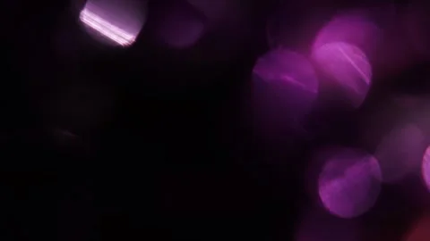 Large and small purple bokeh lights in black 库存影片 318947722