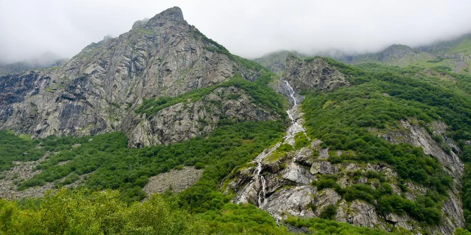 Large and small rivers and waterfalls in North Ossetia against the backdrop o Stock Photos