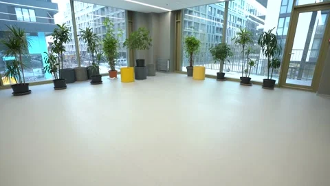 Large and spacious corridor in business centre. Big hall with flowers Stock Footage 172070186