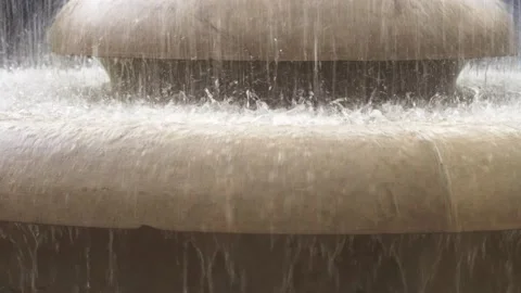 Large and strong splashes of water on the stone base of the fountain in a Stock Footage 193536496