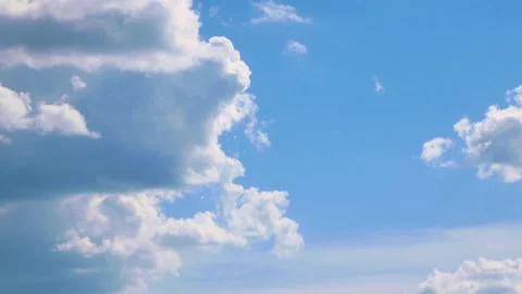 Large and voluminous white fluffy clouds floating in the blue sky Stock Footage 131864307
