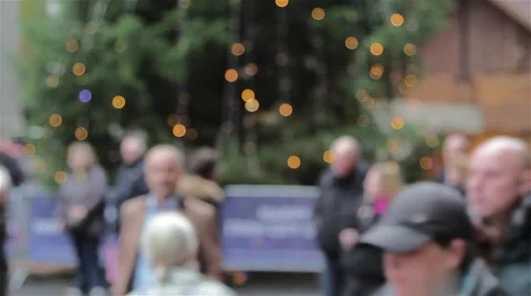 Large Anonymous Crowd Walk Past Out of Focus Xmas Tree Lights Stock-Footage 44519614