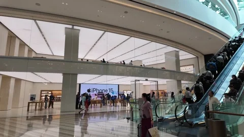 A large Apple store with people walking around Stock Footage 315547801