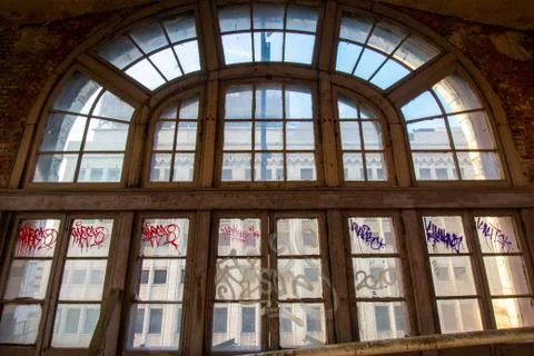A Large Arched Window in an Abandoned Building Stock Photos