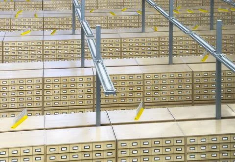 Large archive interior with extensive rows of wooden card catalog drawers and Stock Photos