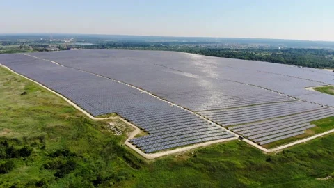 A large area is covered with solar panels. The sun is reflected from solar panel Stock Footage 134489276