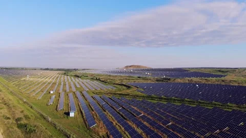 A large area is covered with solar panels. The sun is reflected from solar panel Stock Footage 134490437