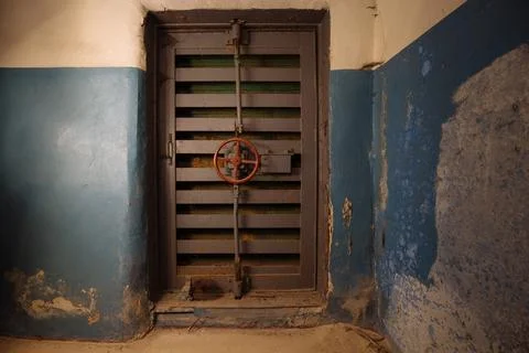 Large armored blast proof iron door with valve inside bomb shelter Stock Photos