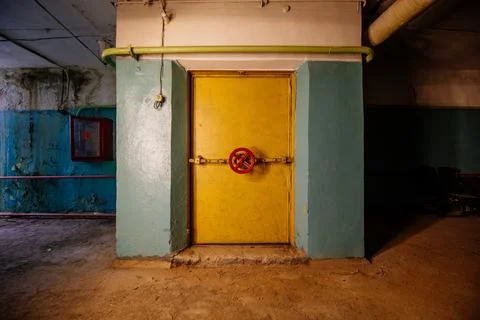 Large armored blast proof iron door with valve inside bomb shelter Stock Photos