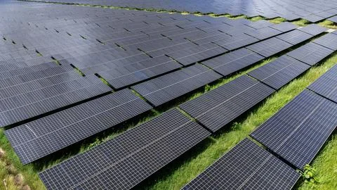 Large Array Of Photovoltaic Panels Capturing Solar Energy In An Open Field .. Stock Photos