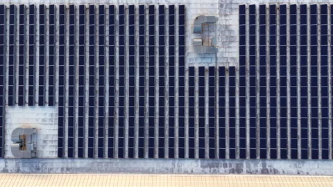 Large array of solar panels covering an industrial rooftop with HVAC Stock Footage 333155950