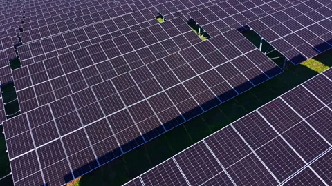 Large array of solar panels in a field under sunlight, showing many rows of Video stock 331976161