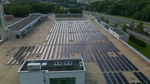 A large array of solar panels on top of a European hypermarket in Stock Footage 250117488