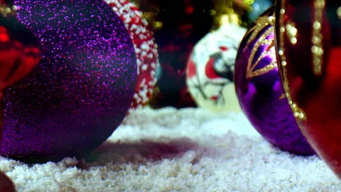 Large artificial snowflakes slowly fall to the surface of Christmas balls. Glass Stock Footage 166105083