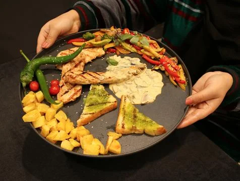 Large assorted Mediterranean platter filled with grilled chicken Stock Photos