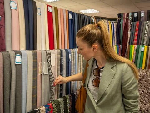 Large assortment of bright fabrics in the store. A tailor or fashion designer Stock Photos