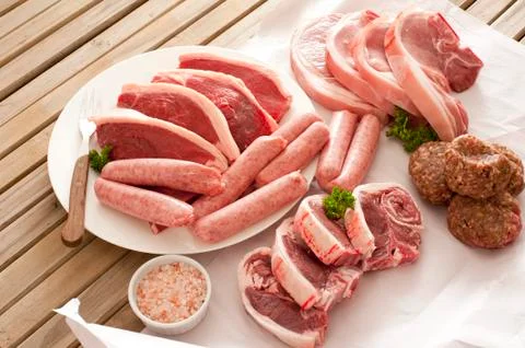 Large assortment of raw meat on a table Stock Photos