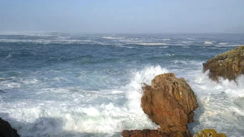 Large Atlantic waves hit the rocks. There is a lot of spray in the air. Stock Footage 135149658