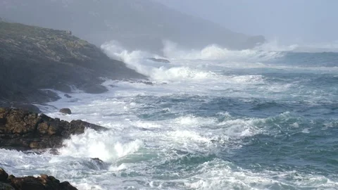 Large Atlantic waves hit the rocky coast in the haze when the sun shines. Stock Footage 135149712