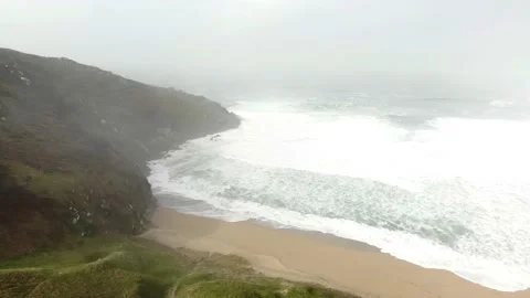 Large Atlantic waves roll onto the beach. Haze and some sunshine. Stock Footage 135149758
