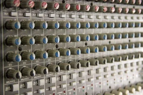 A large audio mixer with many knobs Stock Photos