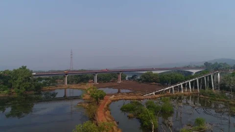 A large automobile bridge over the river, on which cars ride. Aerial view. Video stock 85435820