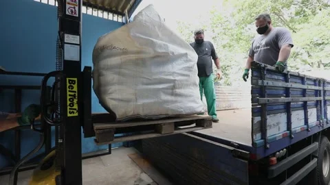 A large bag of used computer components being loaded on a truck to take to Stock-Footage 149793013