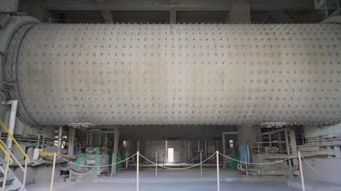 Large ball mill rotating inside cement factory Stock Photos