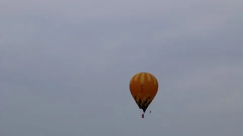 A large balloon, brightly colored, flies over the city. Video stock 140512101