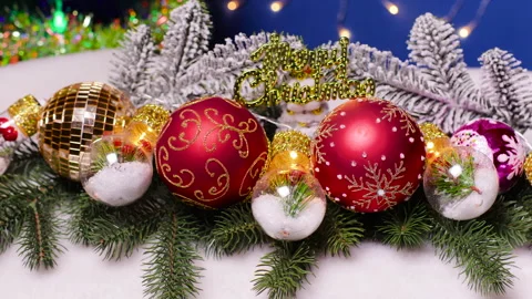 Large balls and decorated lights in the middle lie on Christmas tree branches Stock Footage 326450948