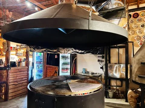 Large barbecue setup in a rustic themed kitchen with wooden and metal decor Stock Photos