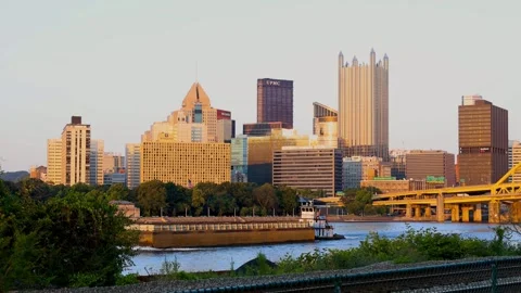 A large Barge sailing on the river at Pittsburgh downtown during twilight. Video stock 324549812