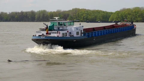 Large barge sailing under the flag of Romania on the Danube river. Stock Footage 239285707