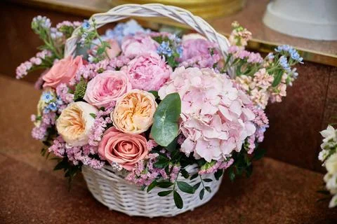 Large basket with flowers. Hydrangea, ranunculus, roses, statice Stock Photos