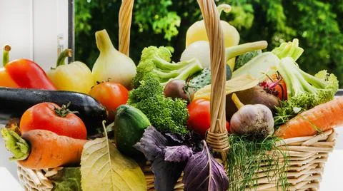 A large basket of vegetables. A set of vegetables for vegetarian dishes. Vege Stock Photos