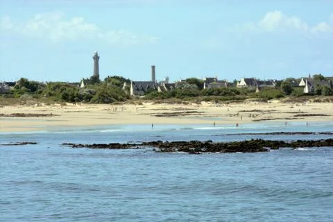 Large beach between ocean and village Stock Photos
