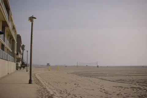 Large beach, volleyball net, light post, townhouses Stock Footage 296705332