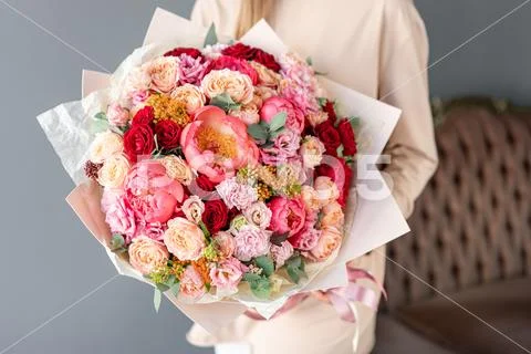 Large Beautiful bouquet of mixed flowers in woman hand. Floral shop concept Stock Photos