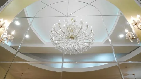 A large beautiful chandelier is reflected in the mirror Stock Footage 139785484