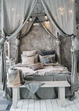 Large bed four-poster bed. Bedroom design Stock Photos