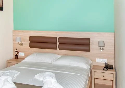 Large bed in hotel room Stock Photos