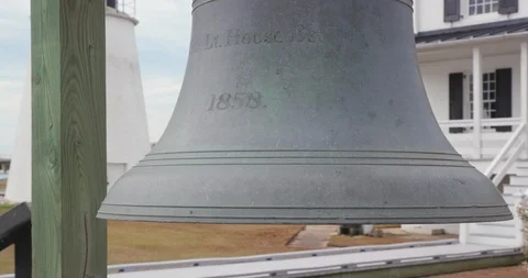 Large Bell Near Lighthouse and Keeper's Quarters Stock Footage 119001663