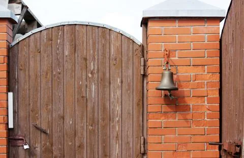 A large bell next to the door, replacing the doorbell. the bell Welcome. Ring Foto stock