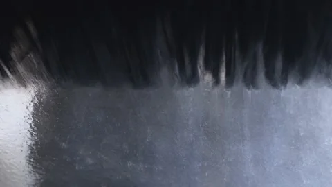 A large black brush washes the windshield of a car.Car wash. Stock Footage 156056823